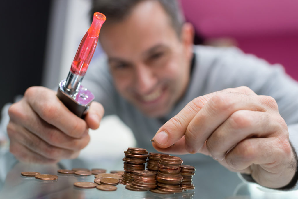 man counting money after saving money by quitting smoking and start vaping for a 2022 new year resolution