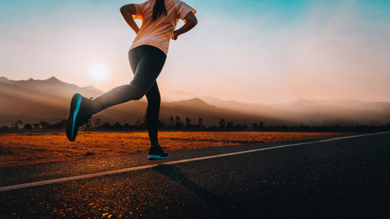 Woman enjoys running outside with beautiful summer evening